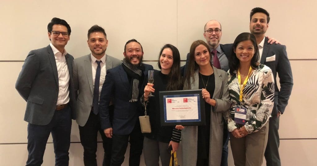 Photo of Mercatus employees holding the Great Place to Work Award.